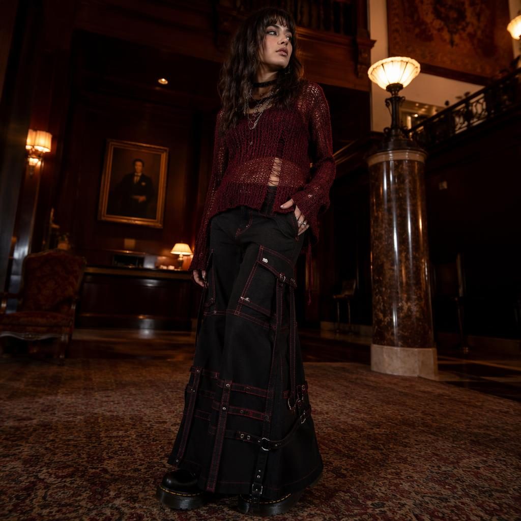 Editorial fashion model in a dark academia outfit in a luxury hotel lobby with autumn rust tones and confident pose.