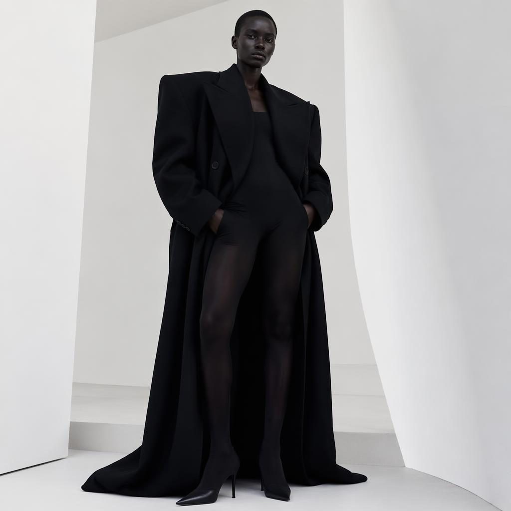 Generic model in a Balenciaga-inspired 2021 lookbook outfit posing in a minimalist white studio with bold lighting