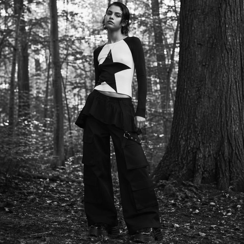 Editorial fashion model in a futurist black and white forest scene wearing a Marc Jacobs Heaven lookbook-inspired outfit