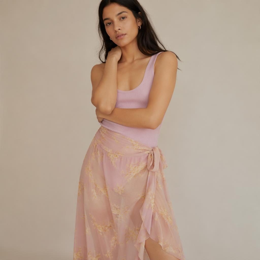 Editorial fashion model in a neutral studio wearing a pastel romantic runway-inspired outfit with a quiet intimate mood