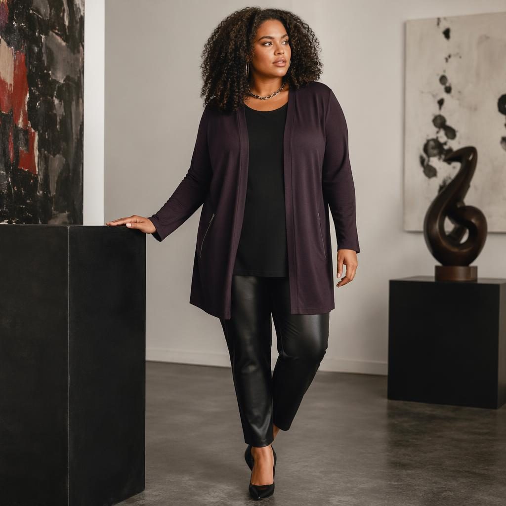 Model in an edgy grunge-inspired women jessica london catalog outfit posing naturally in a modern art gallery