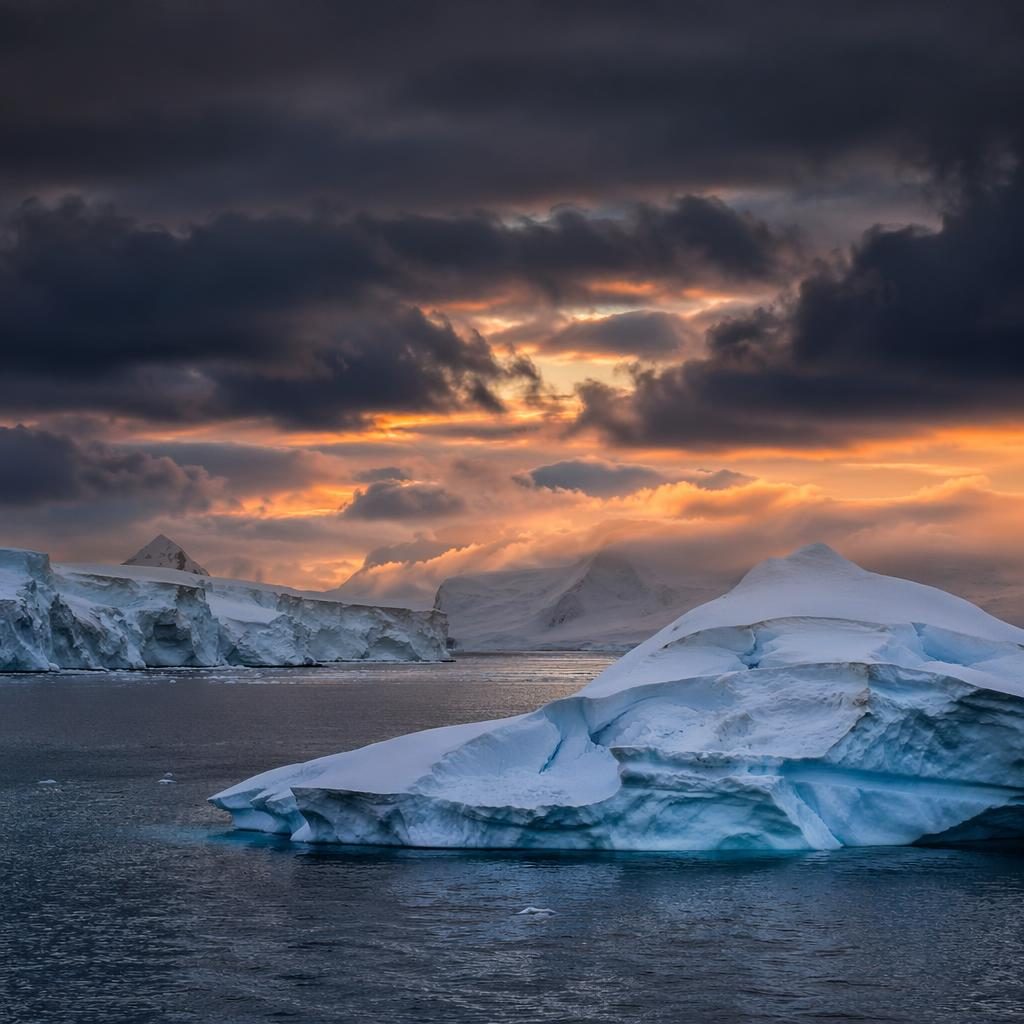 Photoreal Antarctic icebergs at blue hour with dramatic light, calm sea, and overcast sky in a magazine-style landscape.