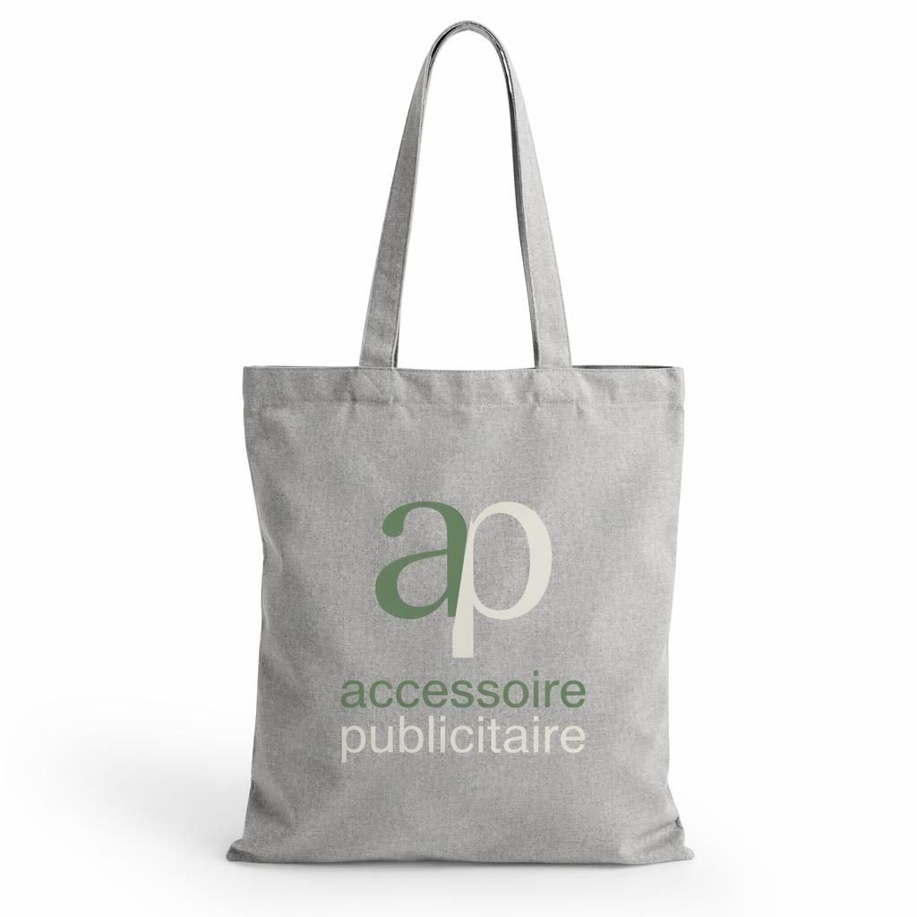 Tote bag gris chiné sur fond blanc minimaliste avec logo sage et ivoire, photo studio nette et texture textile visible.