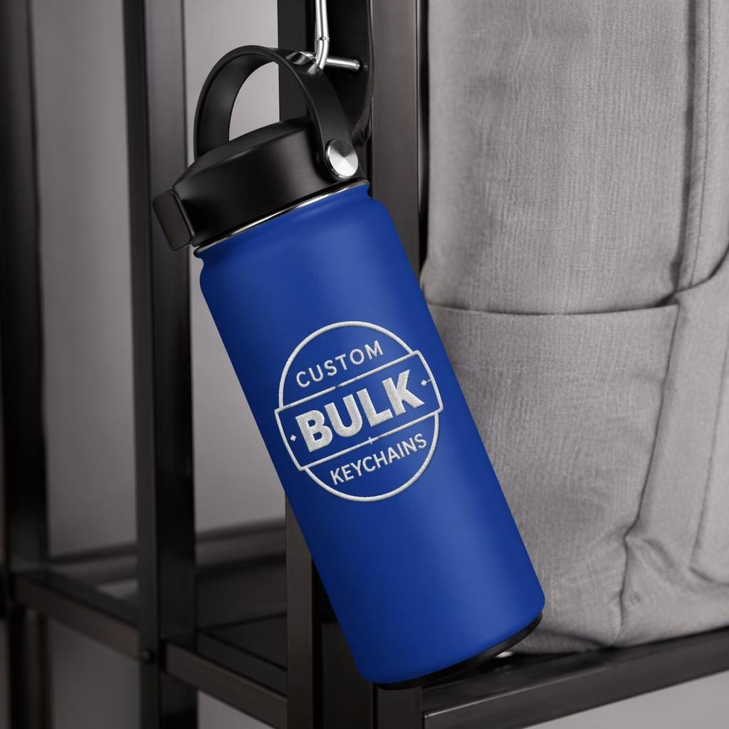 Royal blue water bottle hanging on a rack with a generic custom bulk keychains logo in a minimal monochrome style