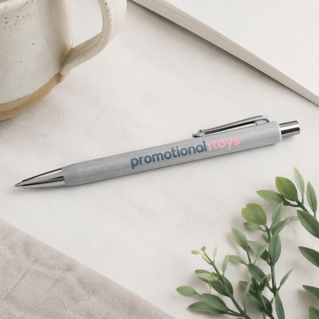 Studio flat lay of a heather gray pen mockup with large promotional toys logo in a soft pastel palette.