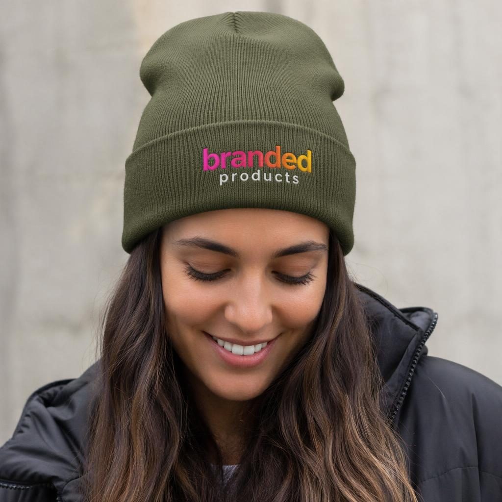 Model wearing an olive green beanie with colorful embroidered branded products logo in a studio product mockup