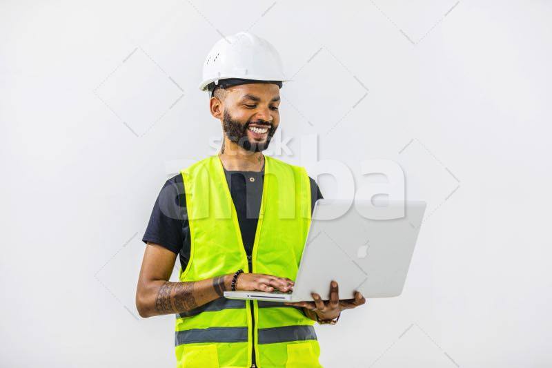 Male Engineer Wearing Hardhat Using Laptop Against White Background ...