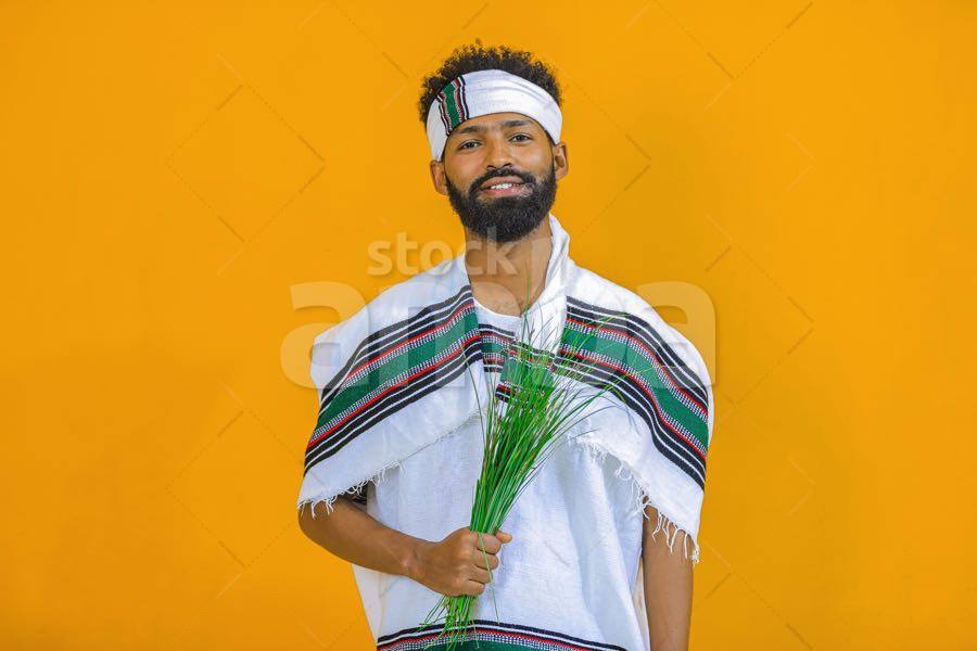 Handsome Man Wearing Oromo Cultural Cloth And Holding Fresh Sedge For Irreechaa CulturalCelebration StockAMBA