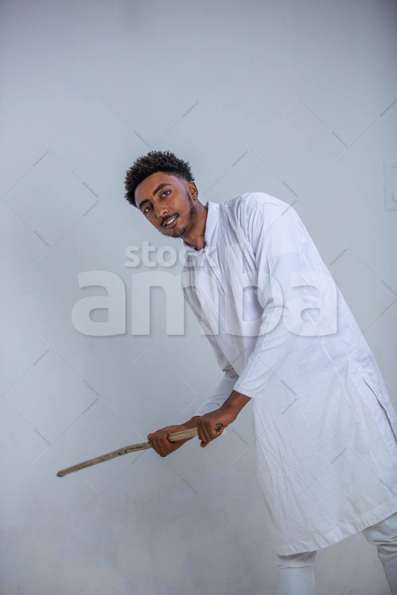 Ethiopian Gentleman Wearing Custom Cloth And Swinging The Rod To Hit ...