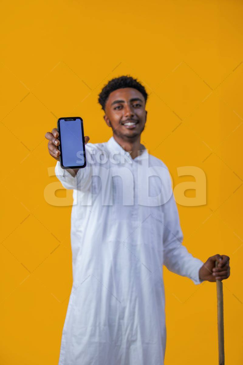 Habesha Guy Holding A Stick While Showing His Phone On Christmas