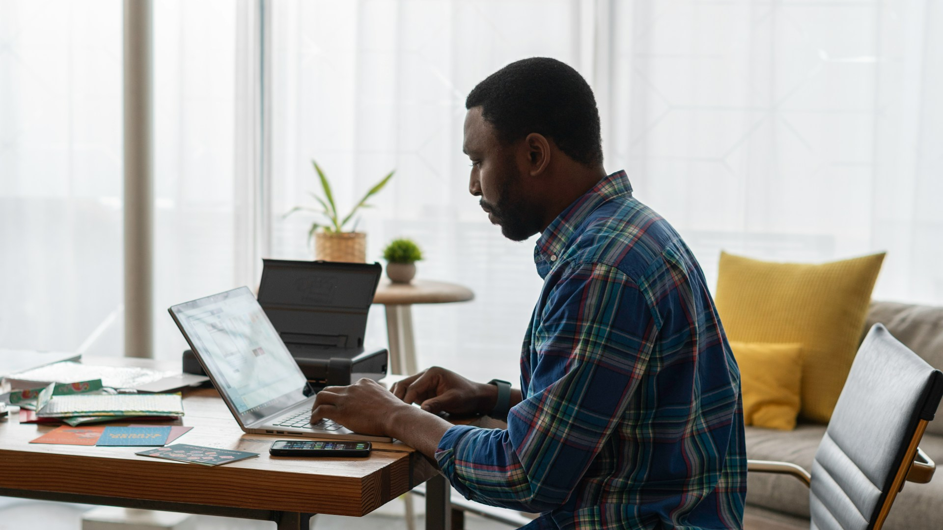 Business owner working through important email threads from a laptop