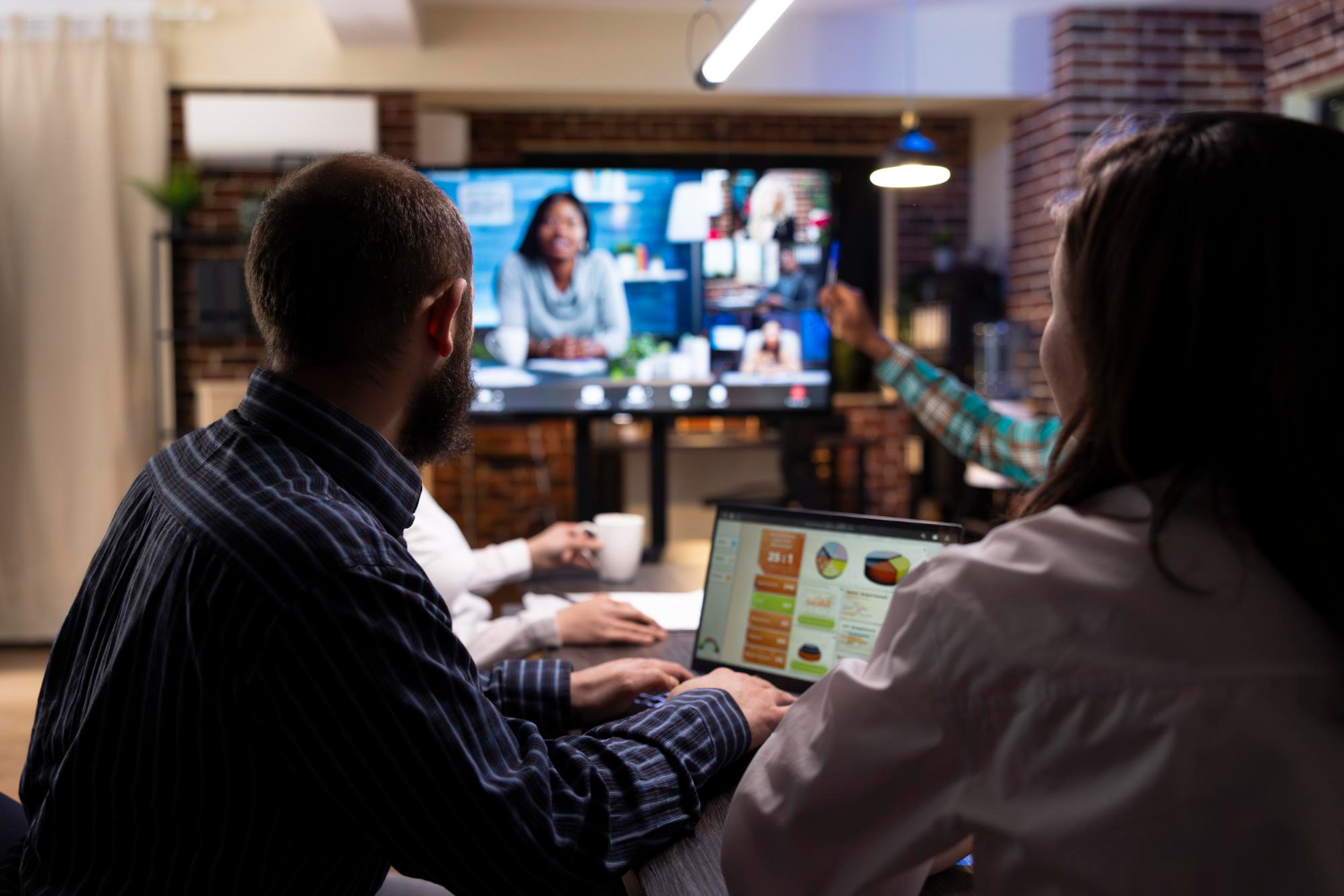 Team collaborating in a meeting with video and chat on screen