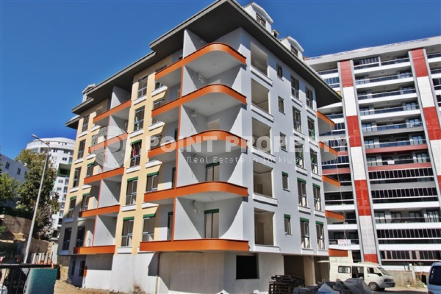 Новая квартира с одной спальней, 55м². в комплексе на этапе строительства в районе Махмутлар, Аланья-id-1694-фото-1
