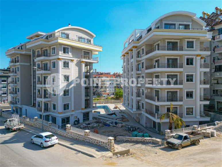 Small 1+1 apartments at the final stage of construction two kilometers from the sea in the prestigious Oba area of Alanya.-id-4403-photo-1